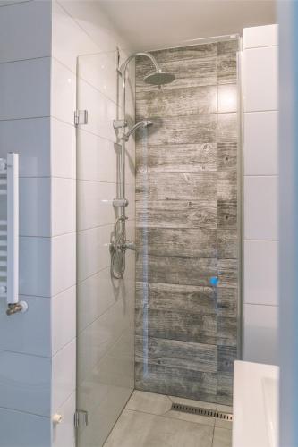 a shower with a glass door in a bathroom at Jastra-Bay in Jastarnia