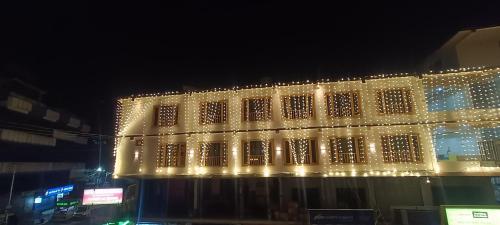 a lit up building with christmas lights on it at HOTEL ROSHAN REGENCY By seraj heritage in Shamshi