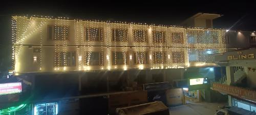 a lit up building with christmas lights on it at HOTEL ROSHAN REGENCY By seraj heritage in Shamshi