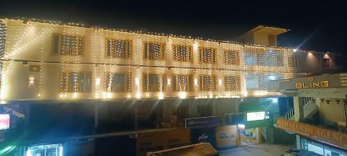 a lit up building with christmas lights on it at HOTEL ROSHAN REGENCY By seraj heritage in Shamshi