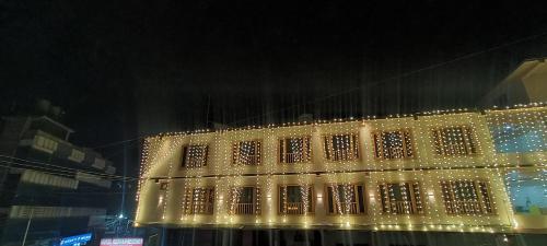 a lit up building with christmas lights on it at HOTEL ROSHAN REGENCY By seraj heritage in Shamshi