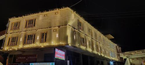 a lit up building with christmas lights on it at HOTEL ROSHAN REGENCY By seraj heritage in Shamshi