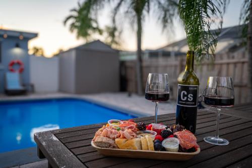 a plate of food and two glasses of wine on a table at October Special! Limited-time Discount Book Now! in Jupiter