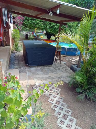 a garden with a large tv sitting on a patio at Chácara com acesso à represa in Ibiúna