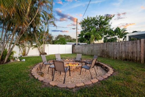 a fire pit in a yard with chairs around it at October Special! Limited-time Discount Book Now! in Jupiter