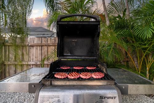 a grill with hamburgers on top of it at October Special! Limited-time Discount Book Now! in Jupiter