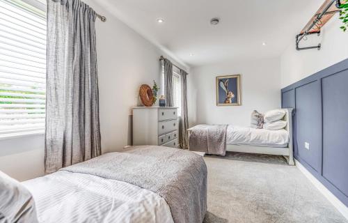 a bedroom with two beds and a window at St Marys Hill Chapel in Tenby