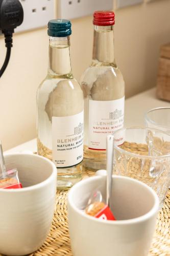 two bottles of vinegar and a bowl on a table at The Olde Coach House Inn in Ashby Saint Ledgers