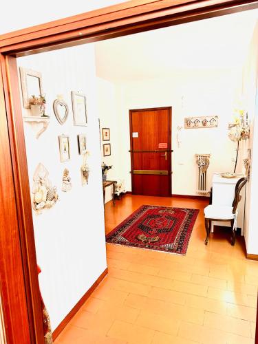 a hallway with a door open to a room with a table at Cisanello Guest House in Pisa