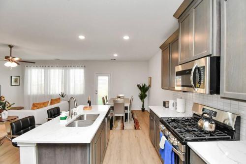 a kitchen with a sink and a stove at Exquisite Relocation and Workers Dream Place in Katy