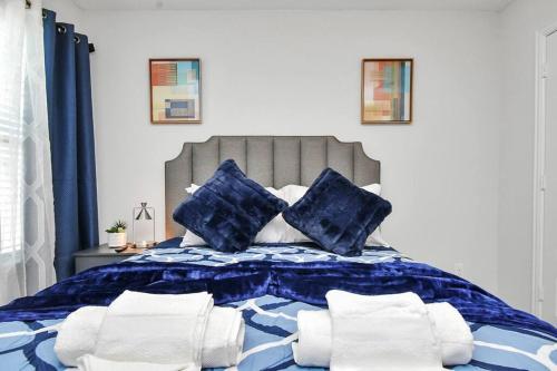 a blue and white bed with blue and white pillows at Exquisite Relocation and Workers Dream Place in Katy