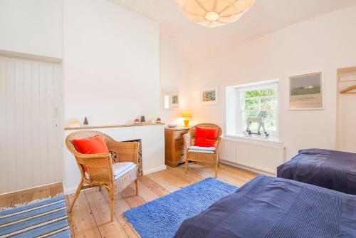 En eller flere senge i et værelse på Rosemary Cottage