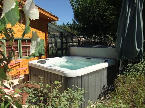 a hot tub in the yard of a house at Gite La Paillote in Montauroux