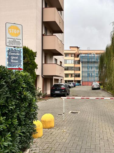 a parking lot with cars parked in front of a building at Cisanello Guest House in Pisa