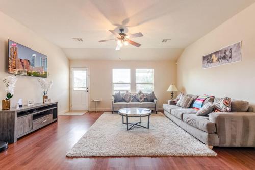 a living room with a couch and a table at Stunning 4-Bedroom Spacious 2-Story Home in Buda