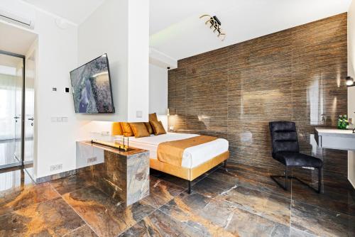 a bedroom with a bed and a desk and a chair at F-Apartments - City Center with Fireplace, Contactless in Tartu