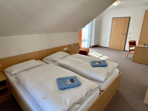 a bedroom with two beds with towels on them at Evangelisches Allianzhaus in Bad Blankenburg
