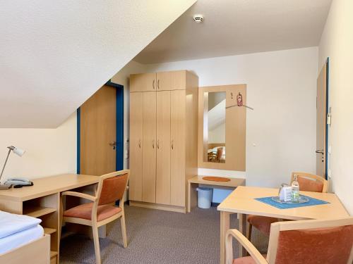 a room with two desks and chairs and a table at Evangelisches Allianzhaus in Bad Blankenburg