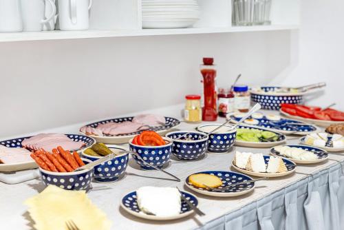 a table topped with blue and white bowls of food at Spa Górka in Szklarska Poręba