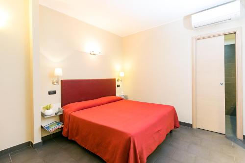 a bedroom with a red bed in a room at Hotel Residenza Gra 21 in Rome