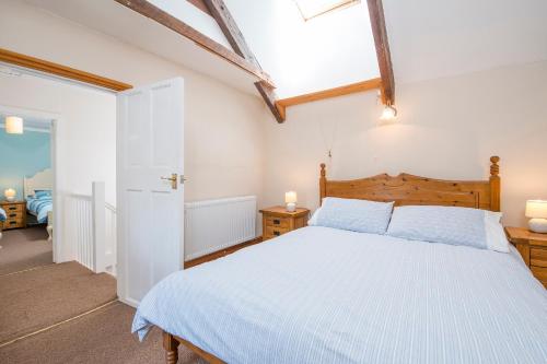 a bedroom with a large bed with a wooden headboard at 3 Tower Hill in Dinas