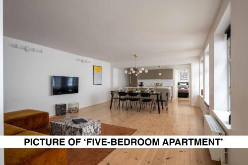 a large living room with a table and a kitchen at Central City Apartment on Best Location by Round Tower in Copenhagen