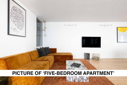 a living room with a couch and a coffee table at Central City Apartment on Best Location by Round Tower in Copenhagen