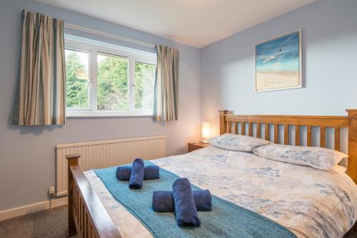 a bedroom with a bed with blue towels on it at Afallon in Haverfordwest