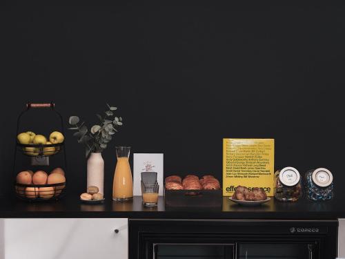 a black counter with bread and other items on it at Bob Hotel in Paris