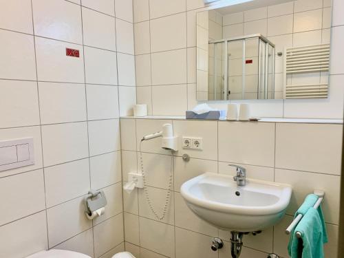 a bathroom with a sink and a mirror at Evangelisches Allianzhaus in Bad Blankenburg