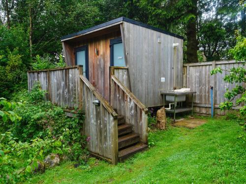 a wooden shed with a staircase and a sink at YHA Eskdale in Eskdale