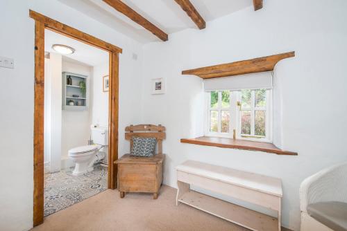a bathroom with a toilet and a window at The Old Dairy in Haverfordwest
