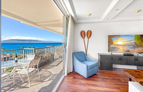 a room with a balcony with a view of the ocean at The Whaler By Maui Resort Rentals in Lahaina