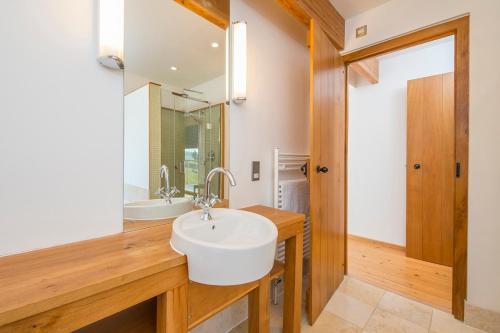 a bathroom with a white sink and a mirror at Nantsaeson in Cardigan