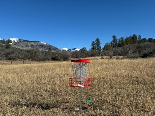 a red frisbee golf basket in a field at 3076 W Highway 160 - Combo in Mancos