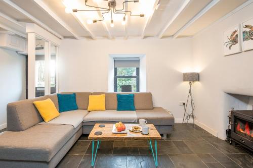 a living room with a couch and a fire place at Ty Cranc Mawr in Haverfordwest