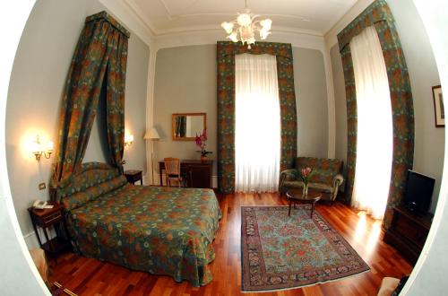 a living room with a bed and a chandelier at Grande Albergo Quattro Stagioni in Rieti