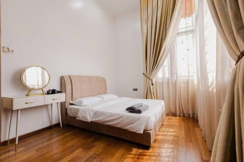 a bedroom with a bed and a mirror and a window at Gelugor 2Storey Big Bungalow 23pax with BBQ Snooker in Gelugor