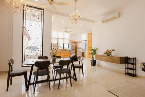 a dining room with a table and chairs at Gelugor 2Storey Big Bungalow 23pax with BBQ Snooker in Gelugor