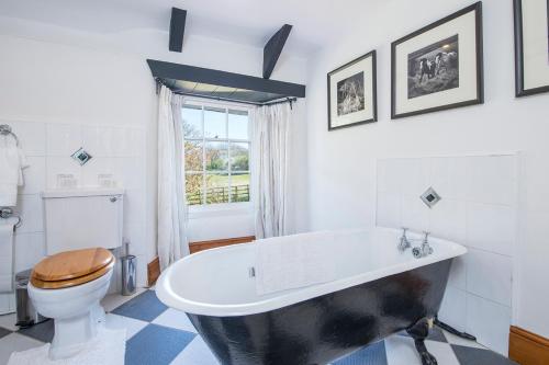 a bathroom with a black and white tub and a toilet at Glebe House in Haverfordwest