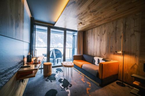 a living room with a couch and a table at Alpina Eclectic Hotel in Chamonix-Mont-Blanc