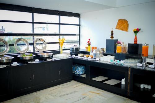 a kitchen with a counter with food on it at Zip by Spree Hotels Mangala International in Coimbatore