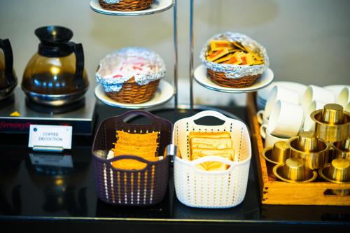 a display case with shoes and baskets on a shelf at Zip by Spree Hotels Mangala International in Coimbatore
