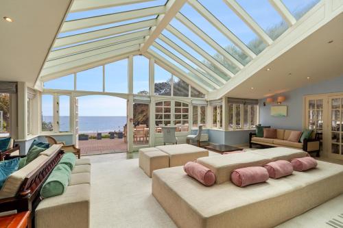 a living room with a conservatory with a glass ceiling at Waterwynch House in Tenby