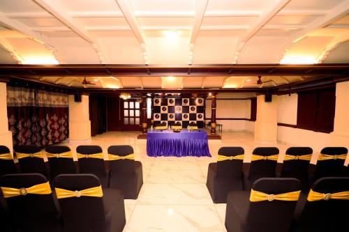 a banquet hall with chairs and a table in a room at Zip by Spree Hotels Mangala International in Coimbatore