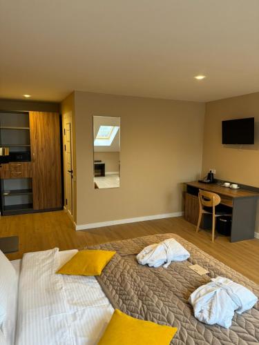 a bedroom with a bed with two towels on it at Guest House Zatyshnyi Dvir in Bukovel