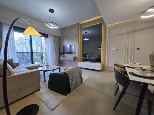 a living room with a couch and a table at Chic 1BR Retreat , Blvd Views, Walk to Dubai Mall in Dubai