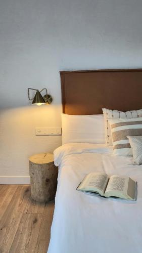 a bedroom with a bed with a book on it at La casa nido in Torrejón el Rubio