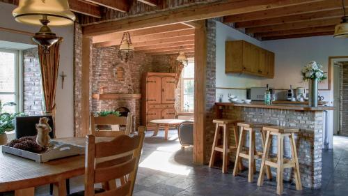 a kitchen and dining room with a table and chairs at Natuurpoort van Loon in Loon op Zand