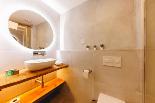 a bathroom with a sink and a mirror at Bravissimo Turbau Entresol B, with 3 bedrooms in Girona